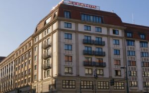 Grand hotel exterior under a clear sky illustrating opportunity zone hotel investing