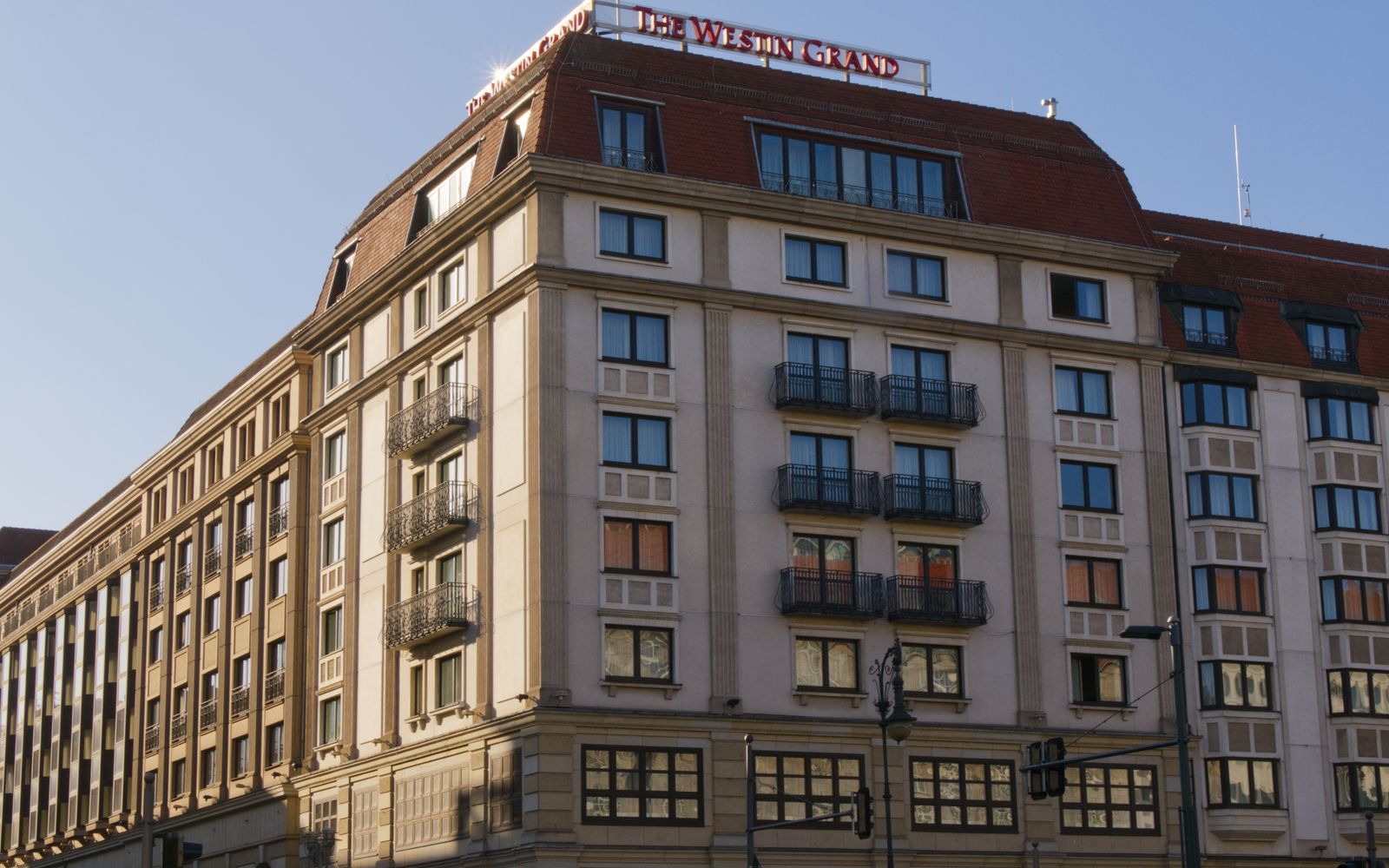 Grand hotel exterior under a clear sky illustrating opportunity zone hotel investing