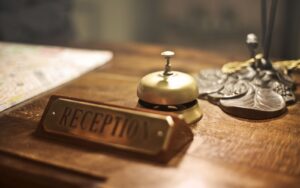 Hotel reception desk with a service bell, representing a hotel syndication K-1 investment