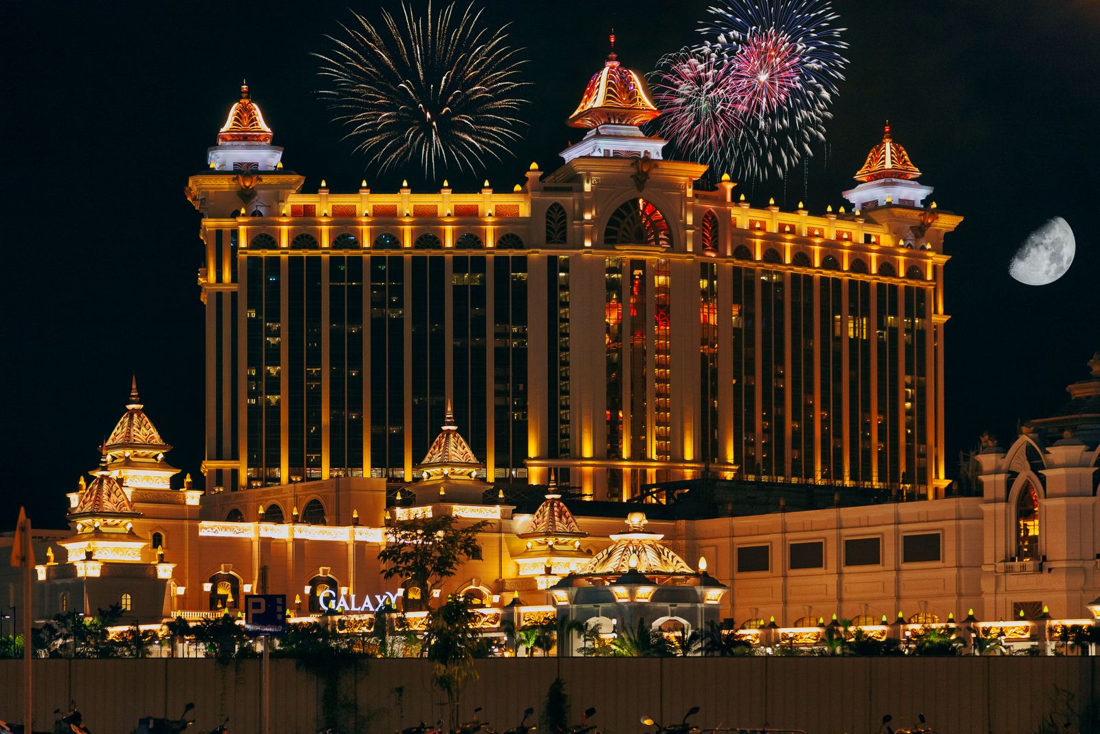 Modern luxury hotel exterior at night illustrating hotel tax benefits for accredited investors
