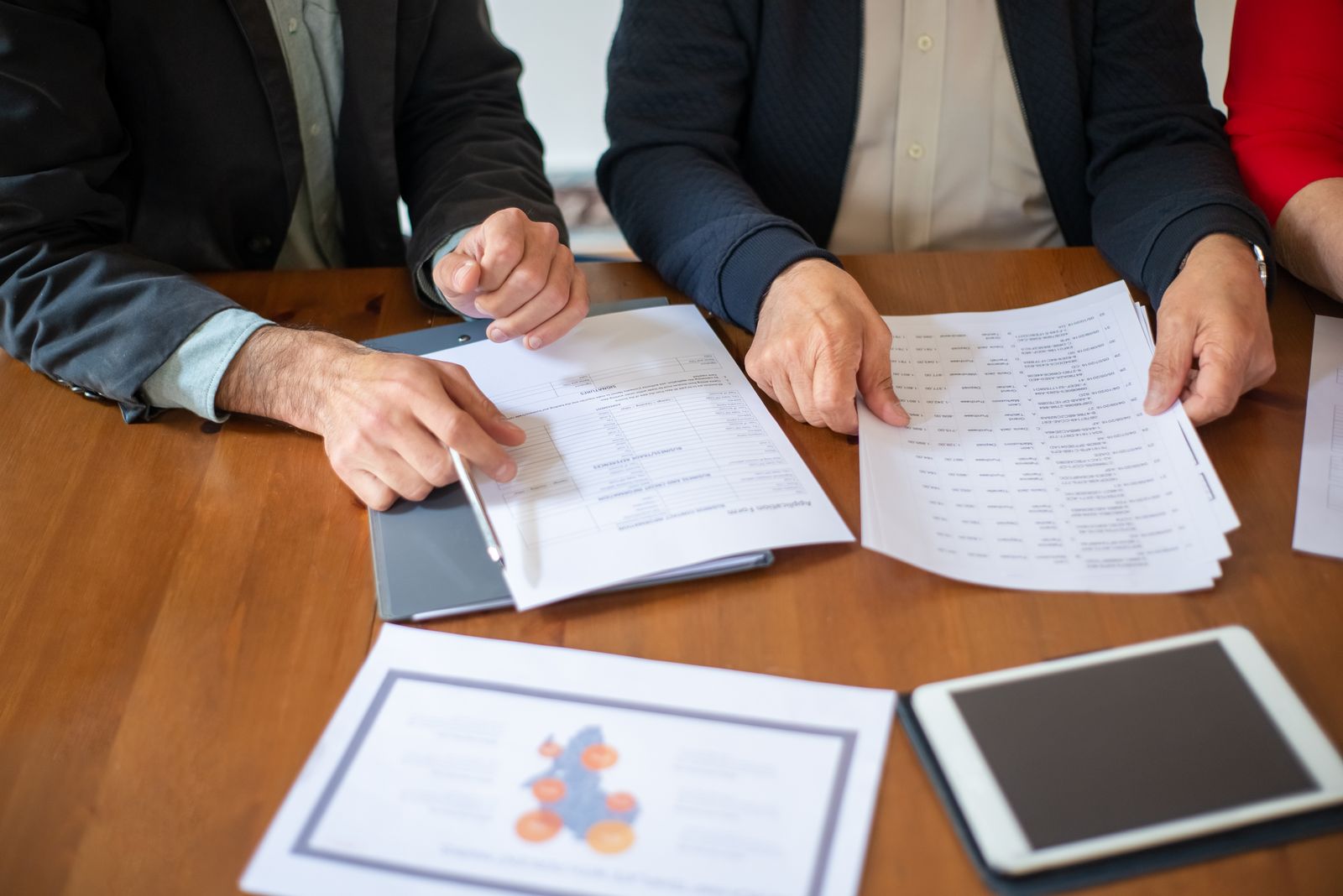 Professionals reviewing documents to understand hotel tax benefits for accredited investors